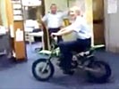 Police woman owned while riding motorcycle indoors.