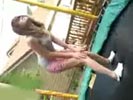 Dumb girl gets her head stuck on a trampoline.