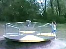 Little girl tossed in the air by merry go round.