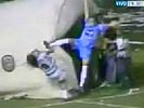 Soccer player delivers a brutal kickbox kick in the face of opponent.