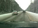 Dashcam records overtaking car starting to slide on icy road.